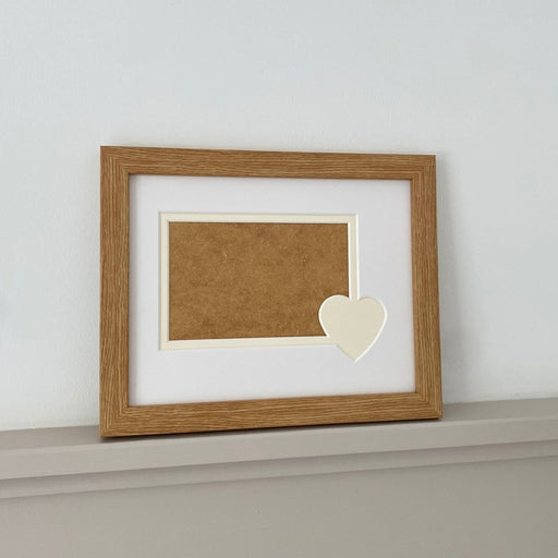 Cream Heart aperture mount and frame on grey shelf