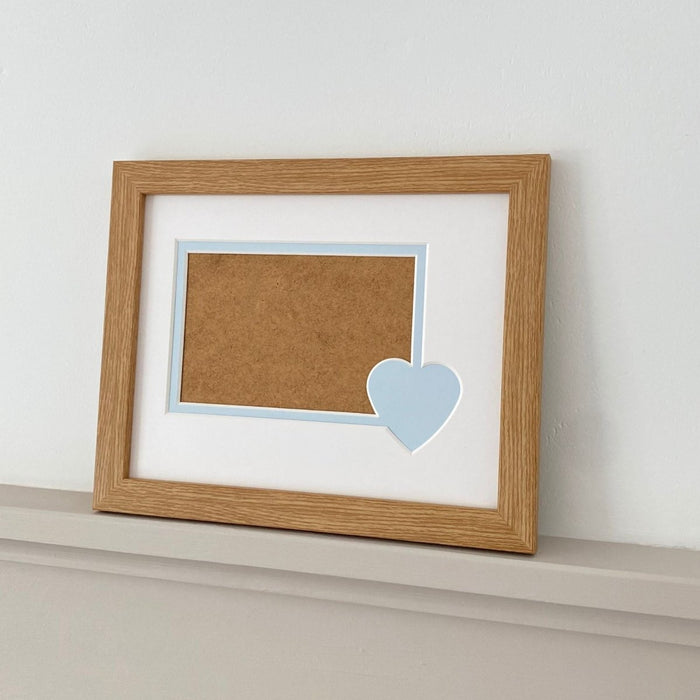 Blue heart mount and light brown frame on grey shelf