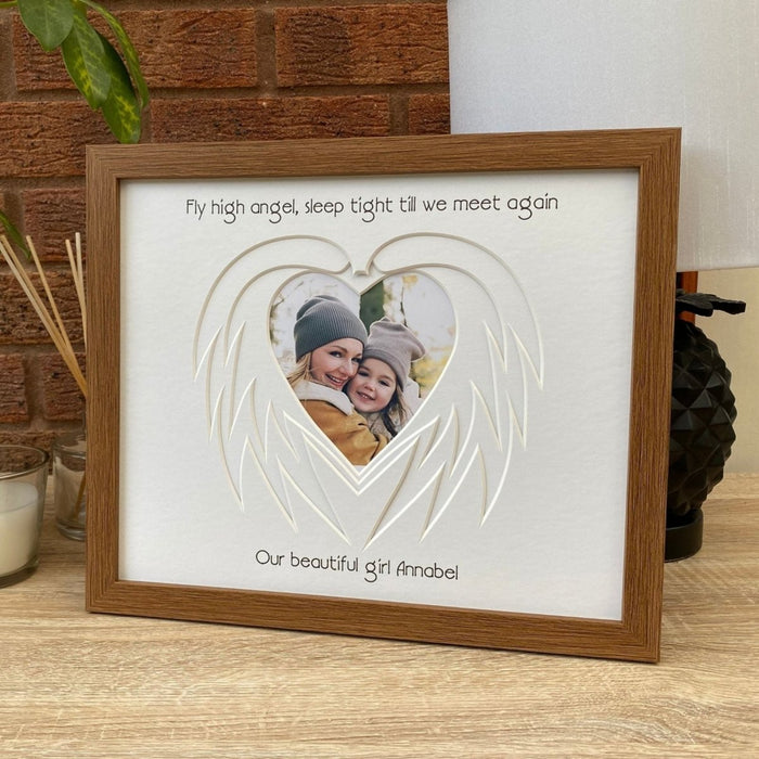 Heart Angel Wing mount in a brown frame on tabletop